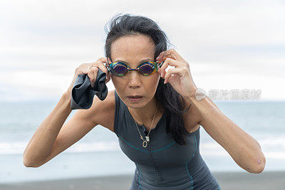 Triathlete woman coming out from sea